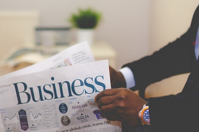 man reading business section of newspaper