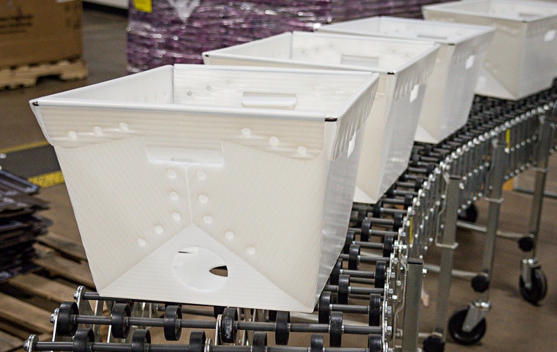 empty while plastic bins on warehouse line