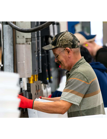 Man working on a production line doing production services and labor