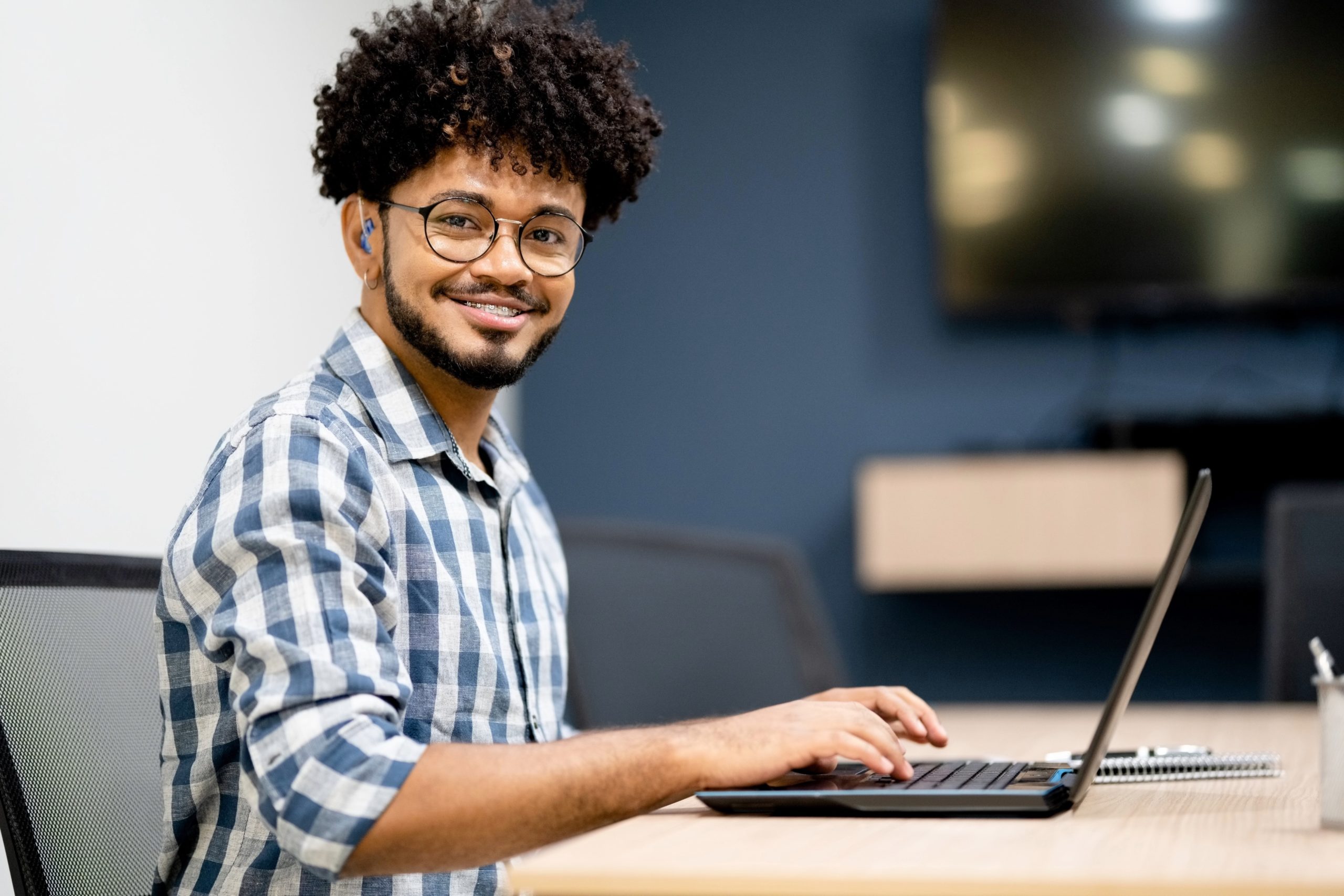 Deaf man on laptop learning from Unified Work online course training