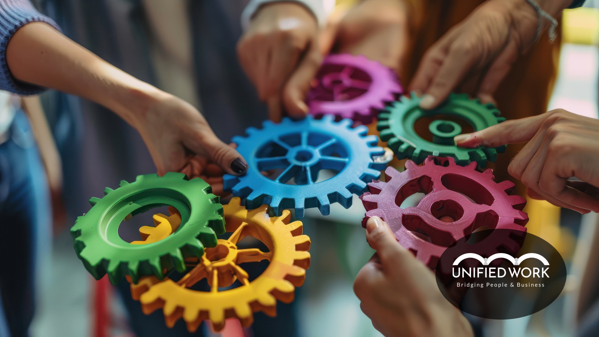 hands holding different sprockets and cogs together