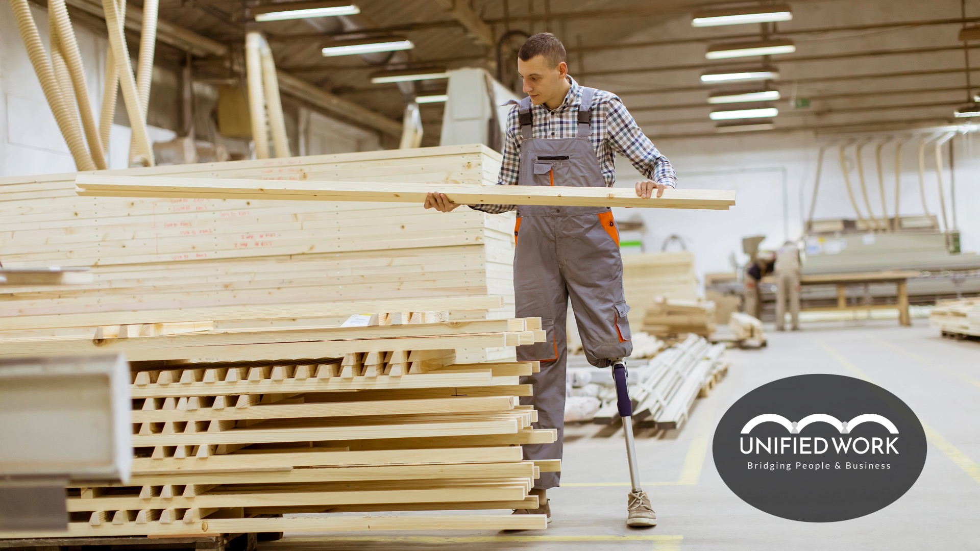 young man with prosthetic leg working in a lumber warehouse