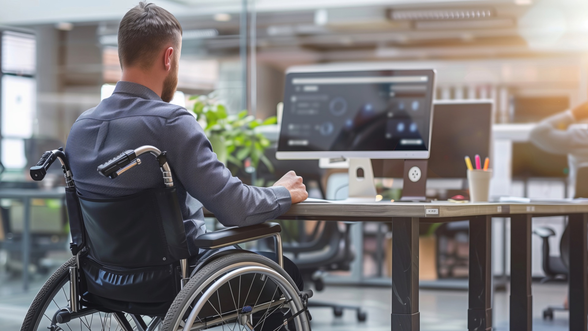 Man at work desk in wheelchair